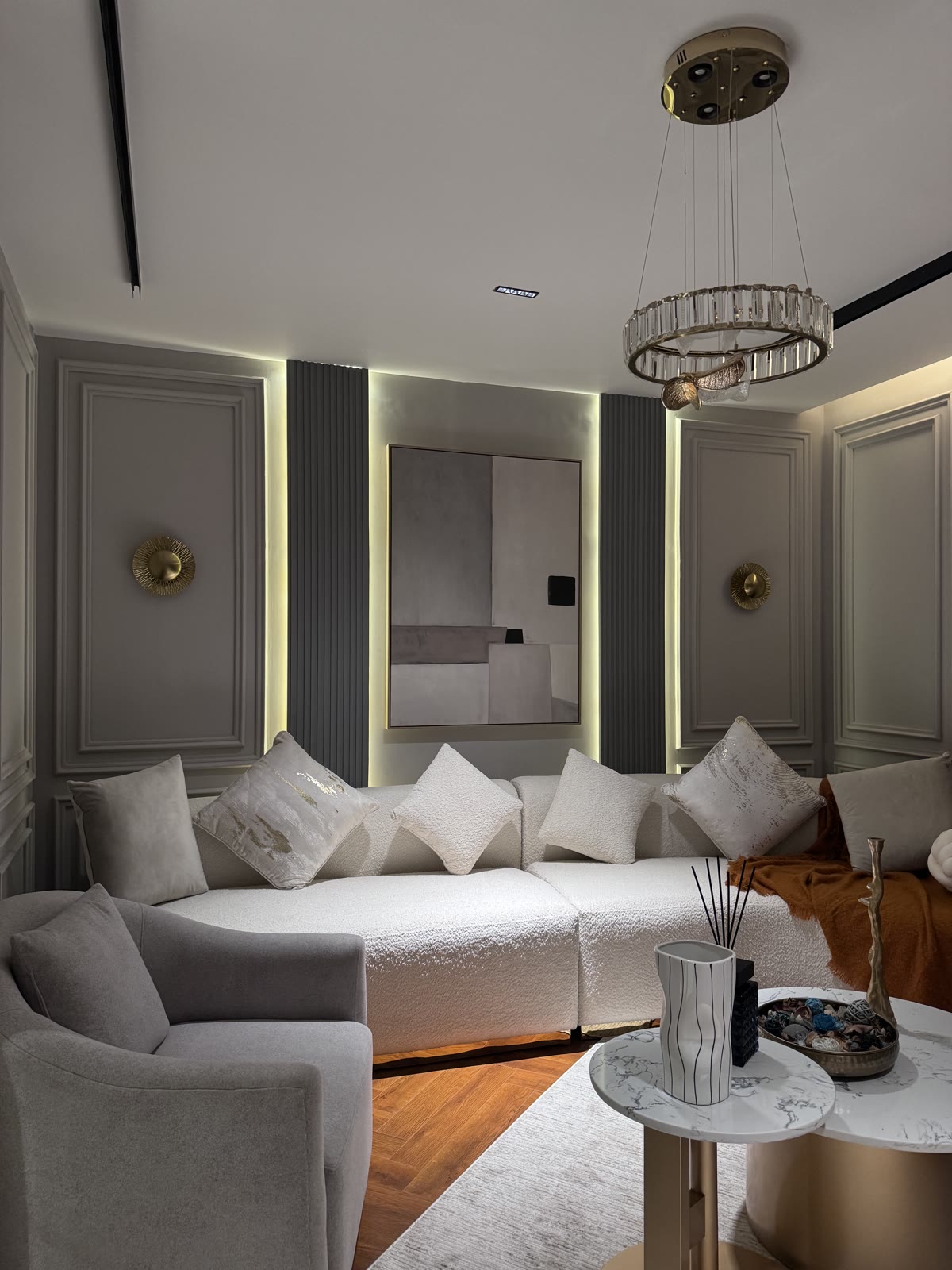 DA Elements panelled living room with crystal chandelier and cove lighting